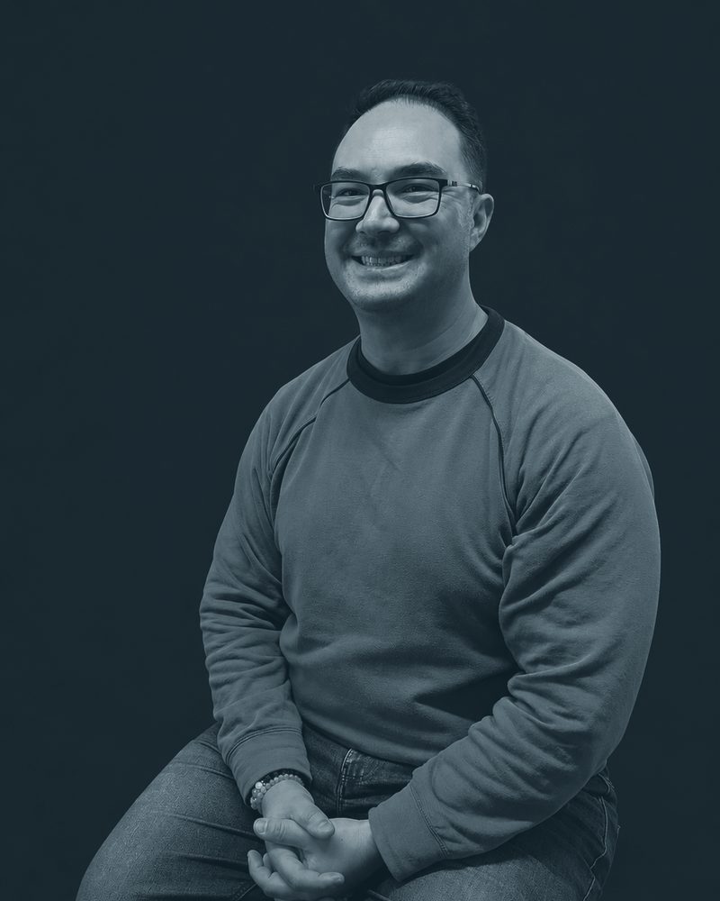 Mark Scales, seated, hands clasped
